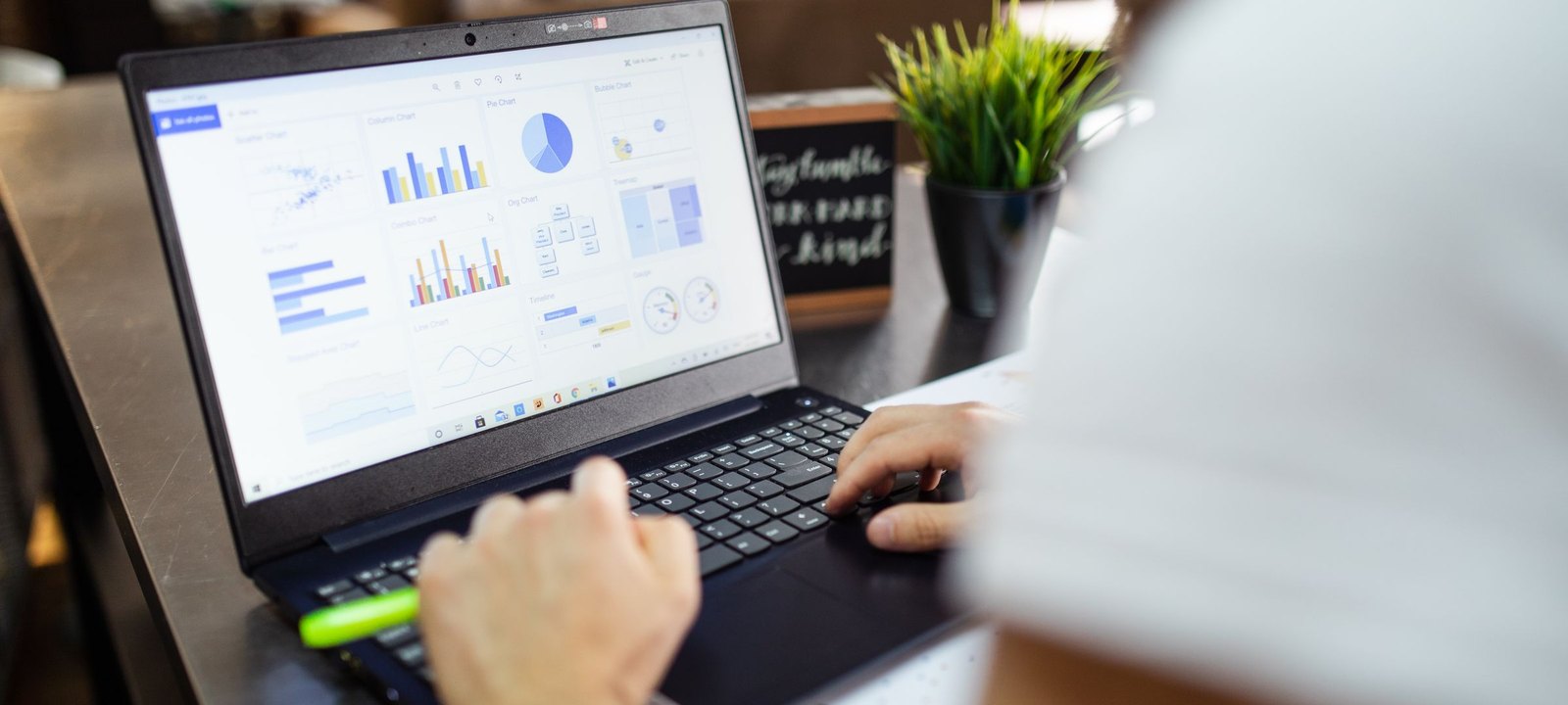 Laptop on a desk showing a dashboard of campaign charts